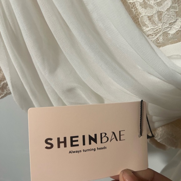 The colors are white and and like a cream color with the rose on the shoulder - Picture 4 of 6